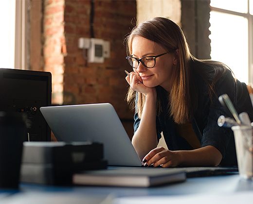 Professional preparing a presentation on a laptop