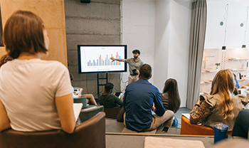 Presenter walking a team through a chart on screen